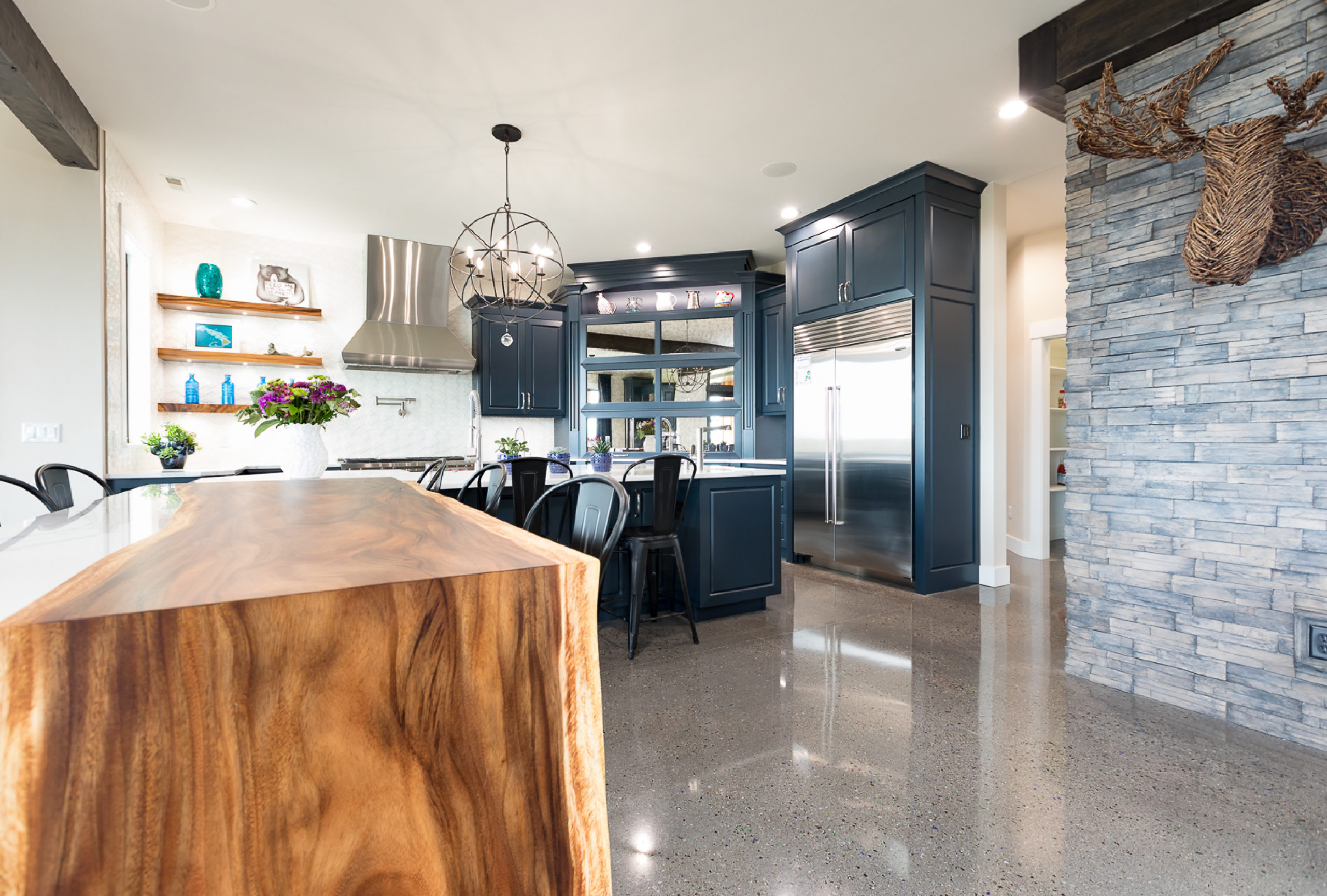 Navy blue kitchen designed by Ban Construction with wooden island
